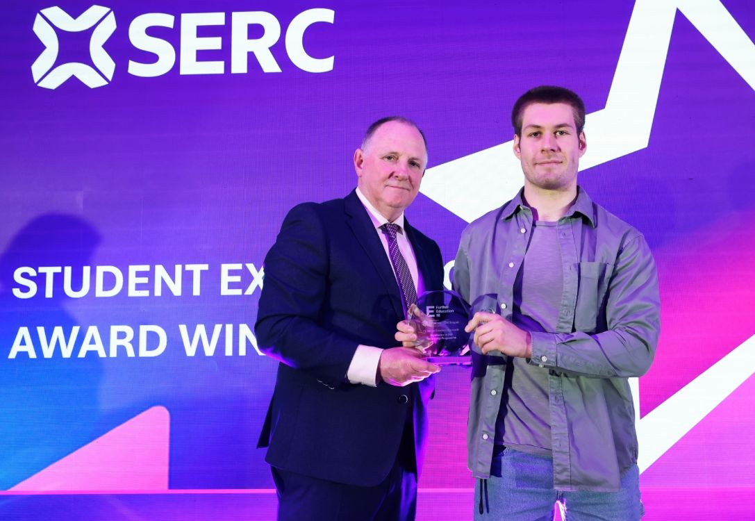 Chair of the SERC Governing Body John Nugent presents Robbie Johnston with the college award for Excellence in a Traineeship Programme 