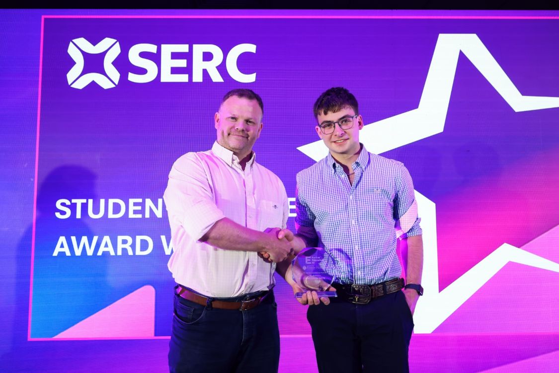 Neil McCann from Timbermark presents apprentice Cameron McRoberts with his award 