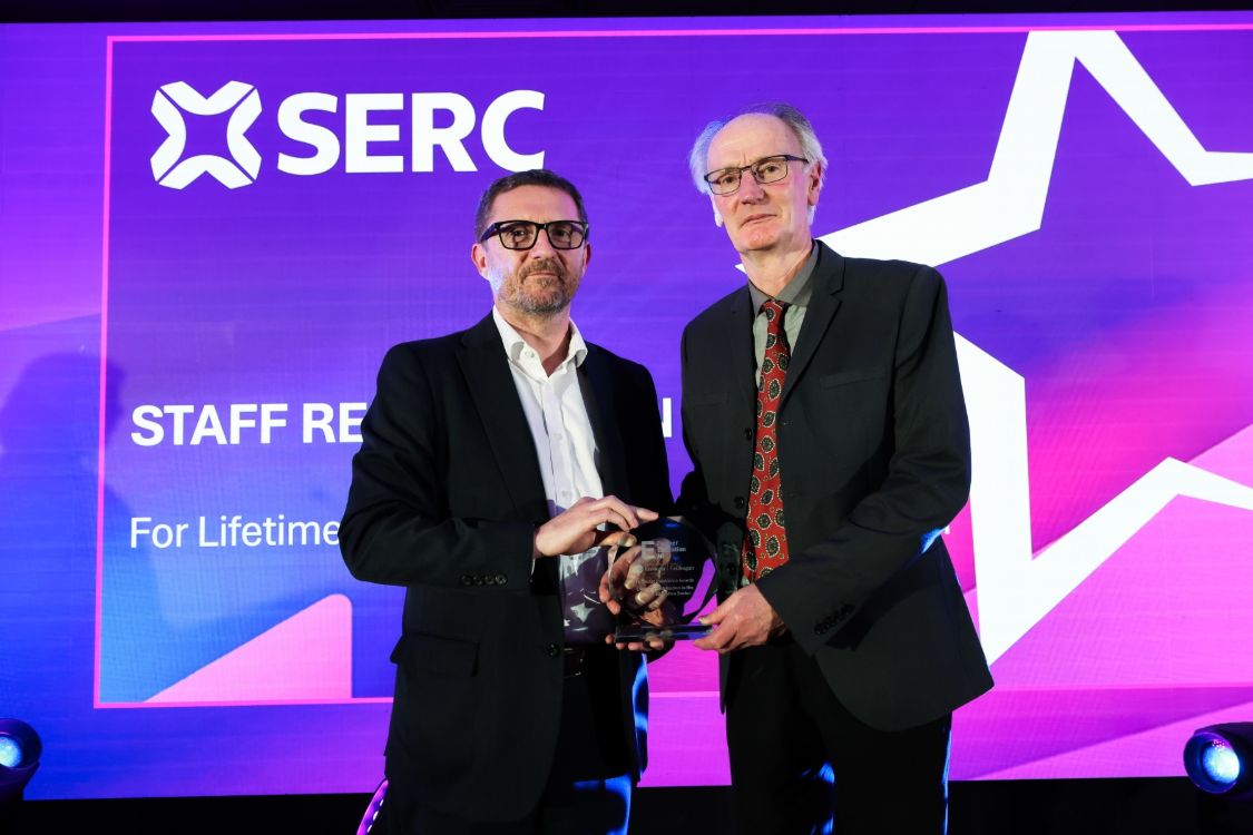 Principal and CEO Tommy Martin presents a staff Lifetime Contribution award to Colin Martin.