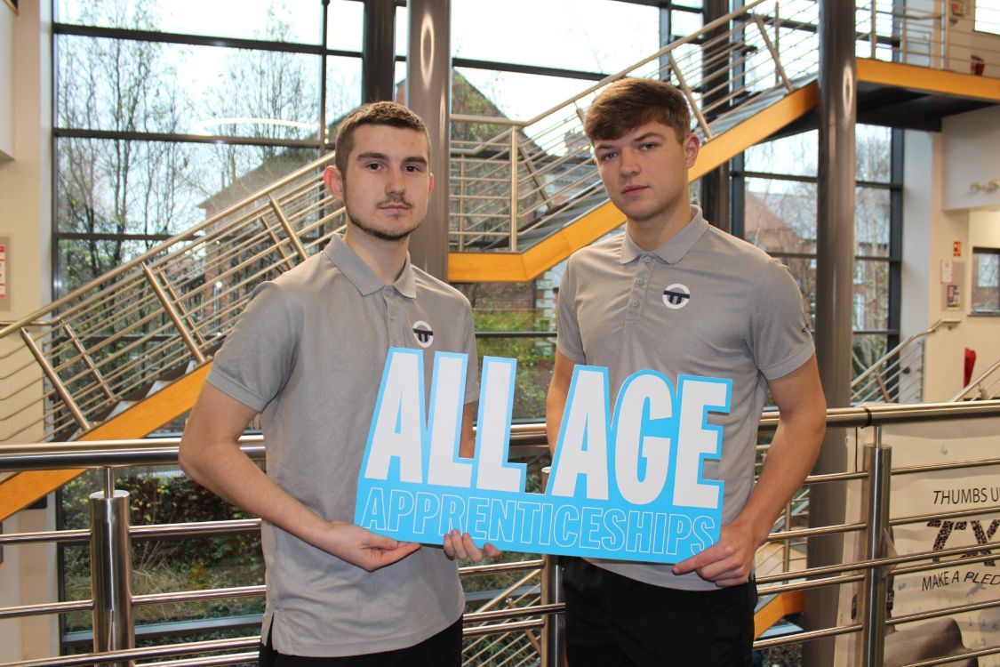 A photo of SERC Apprentices holding a promotional sign that reads: All Age Apprenticeships