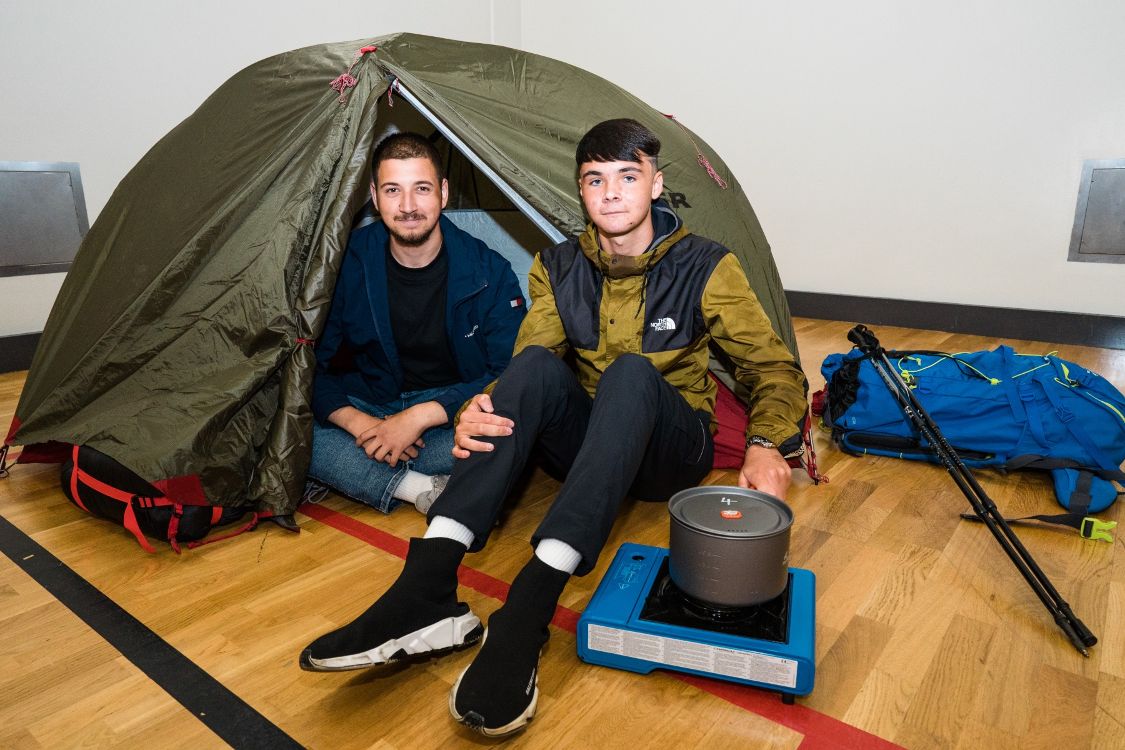 SERC Students sitting outside a tent to showcase camping skills