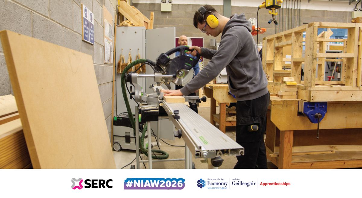 Image showing joinery student cutting a piece of a wood with a large circular saw. 