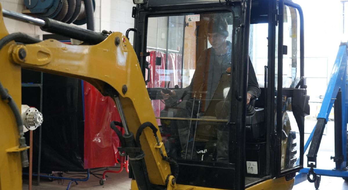 Picture of a student working on machinery 