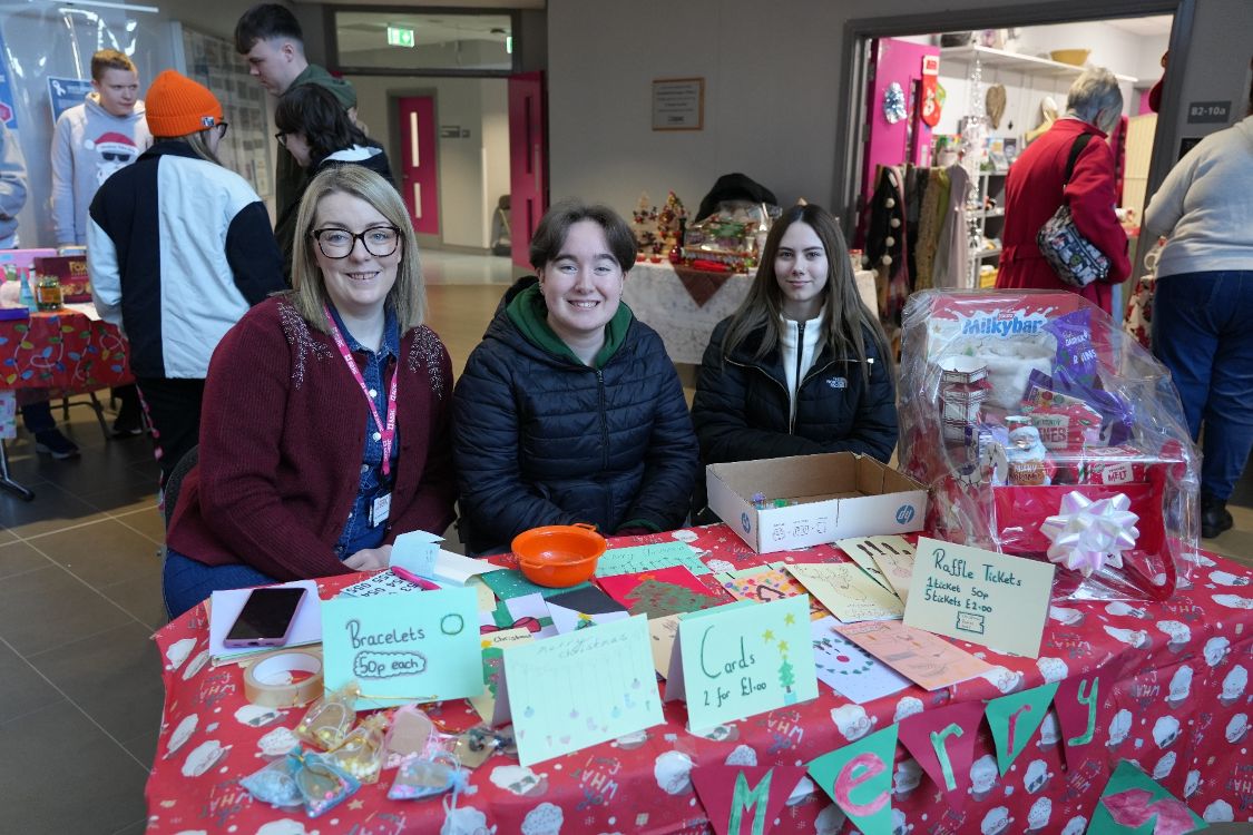 Nicola Watson, Learning Support team with Niamh Obaoill and Rachael Campbell from the Level 2 Traineeship NI in Childcare, hosting a stall selling bracelet kits, cards and tickets for a hamper at SERC’s annual Christmas Market in Downpatrick Campus.