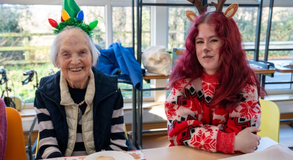 Picture of an Oakmont Lodge resident with a student