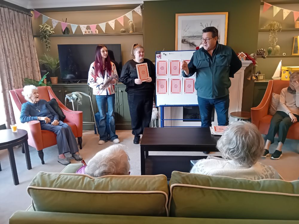 Students enjoy Play Your Cards Right with residents at The Peninsula.