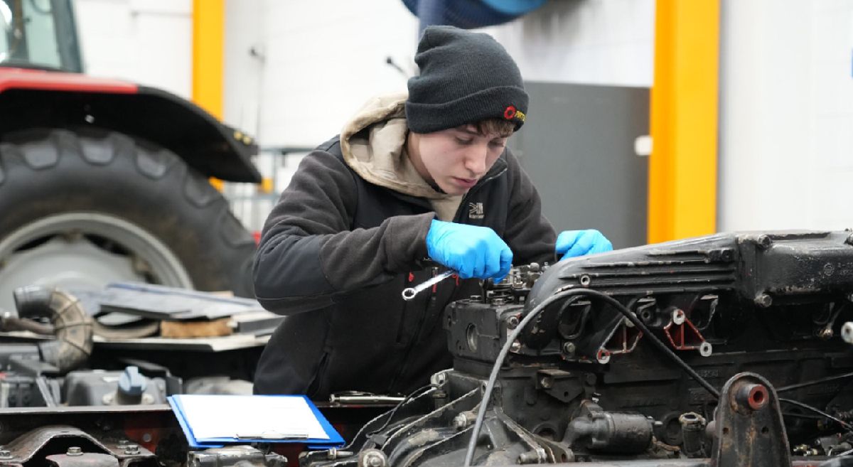 Picture of a student working on machinery 