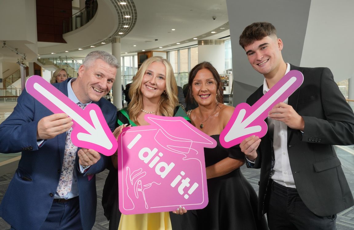 Graduate with family and I did it sigage