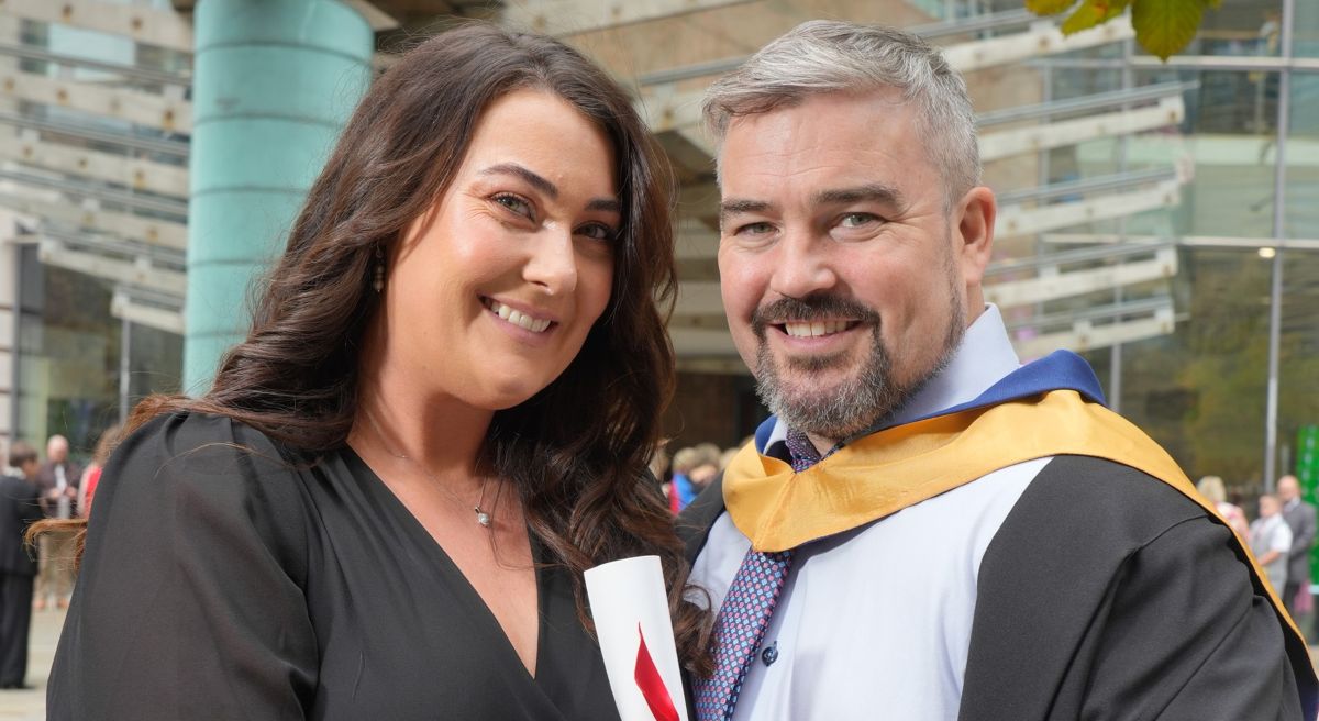 Male graduate with wife