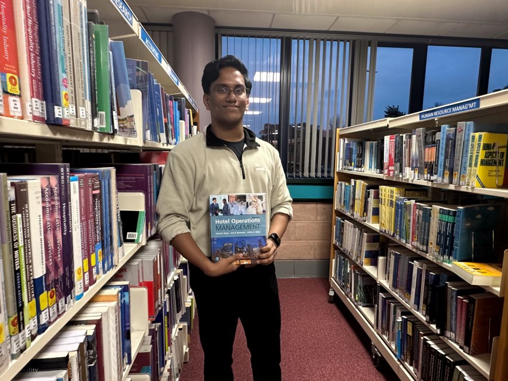 Tom Idiculla in the library at SERC