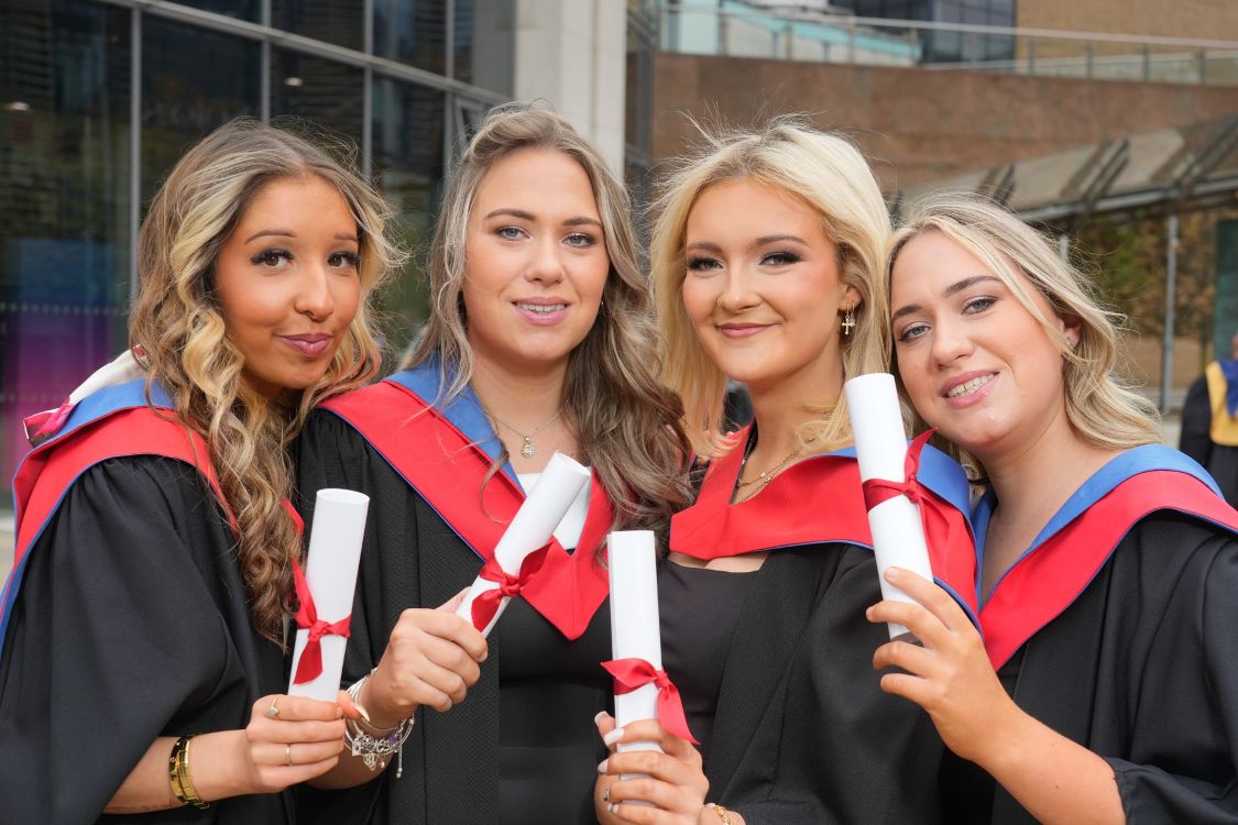 Four female graduates in gowns