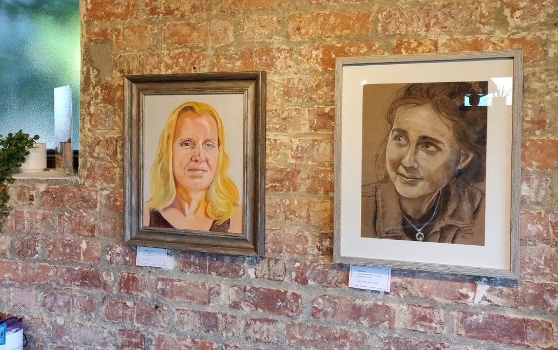 Two framed paintings of women
