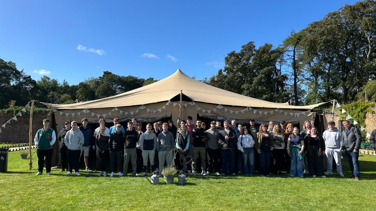 Students at the Walled Garden with marquee in background