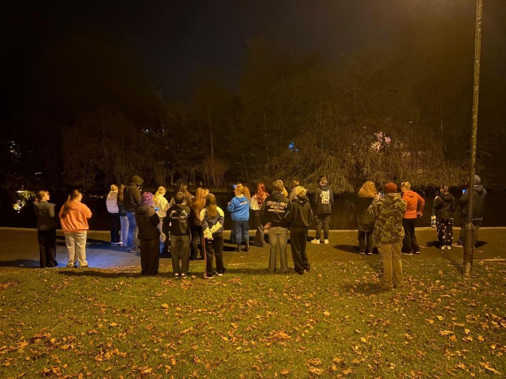 A group of students in a park at night time