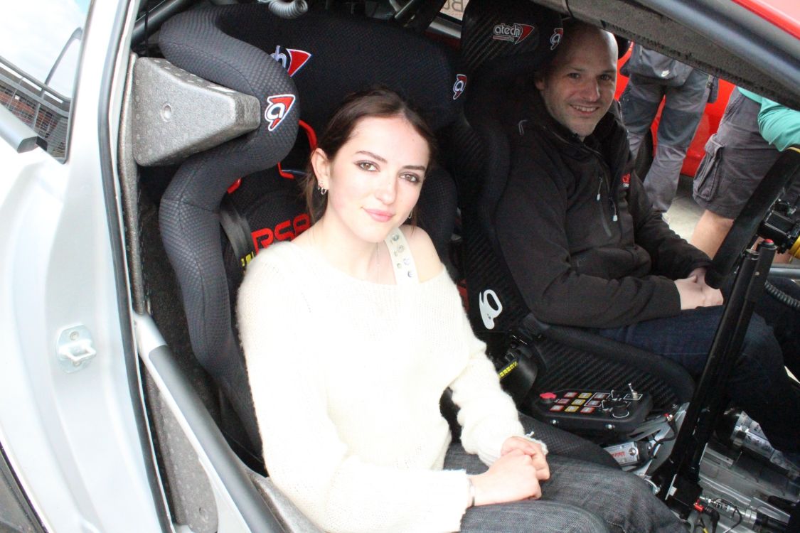 A SERC student and a rally driver sitting inside a rally car