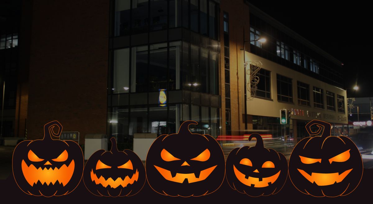 Picture of Downpatrick campus at night with Halloween Pumpkins in the foreground. 