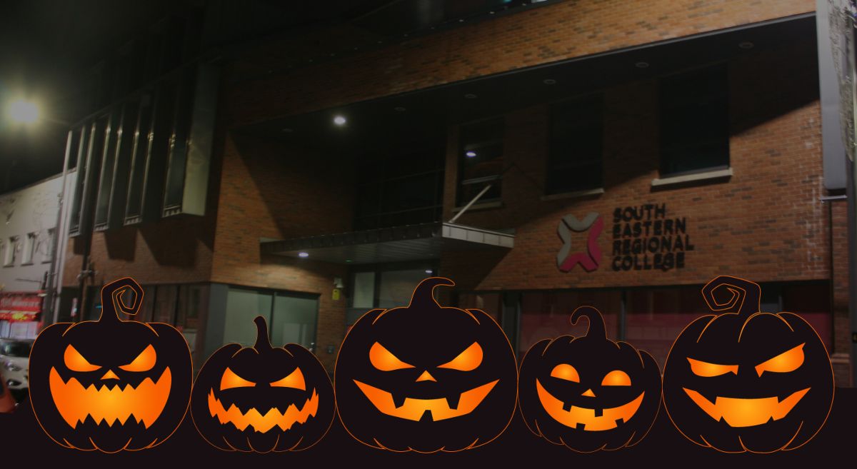 Picture of Lisburn campus at night with Halloween Pumpkins in the foreground. 