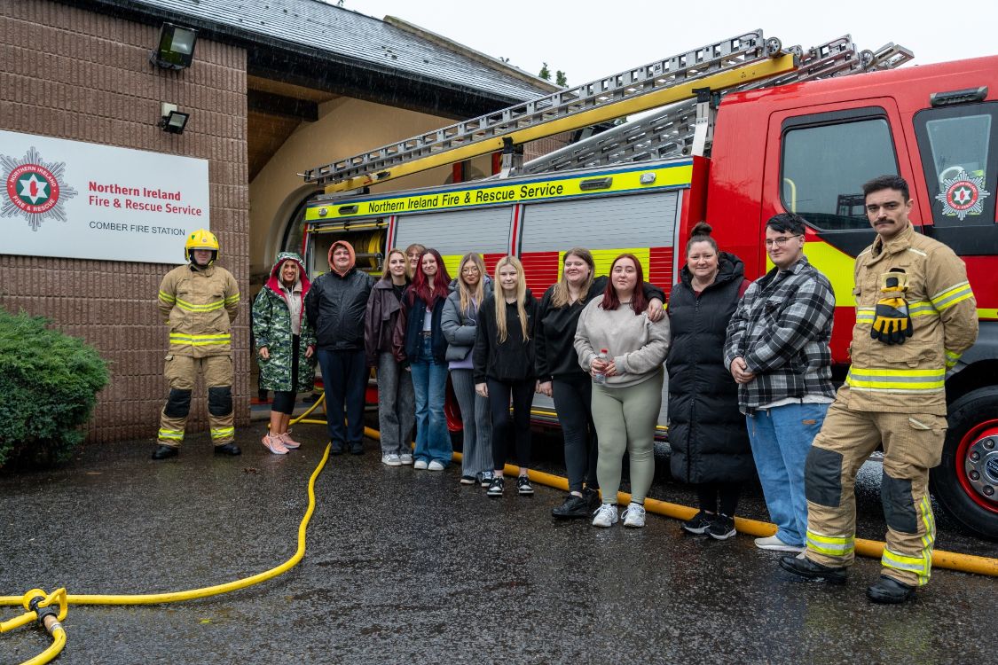 A photo of Level 1 Health Students with Comber Fire Station Fire Engine and Fire Fighters