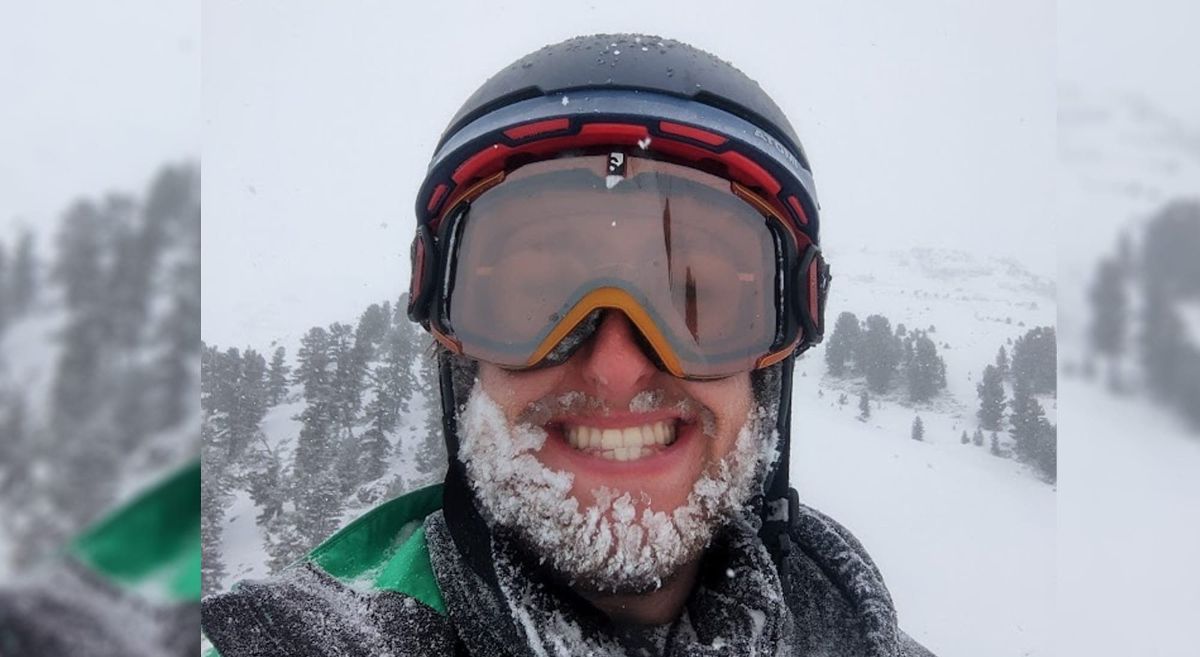 Adam Smylie with ski mask in snowy mountains